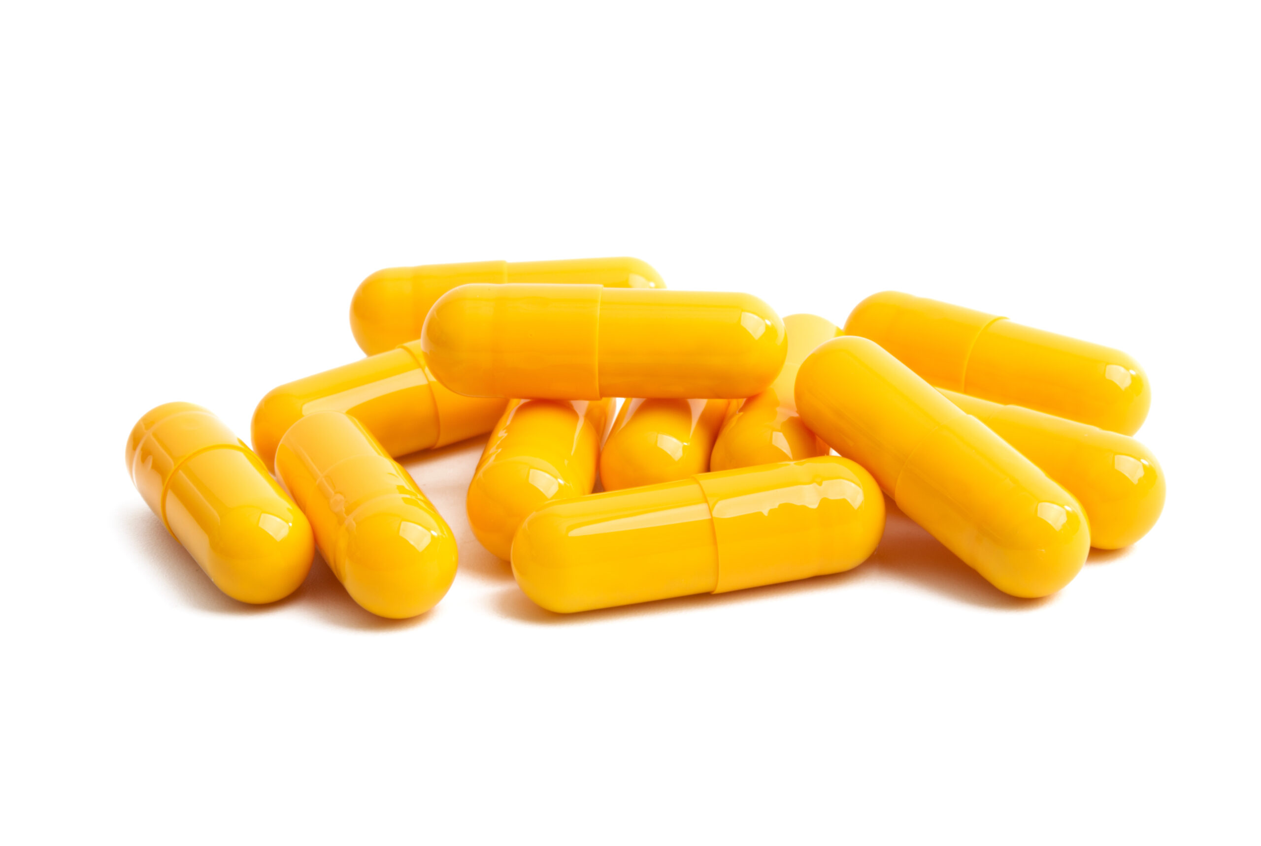 yellow capsules isolated on white background